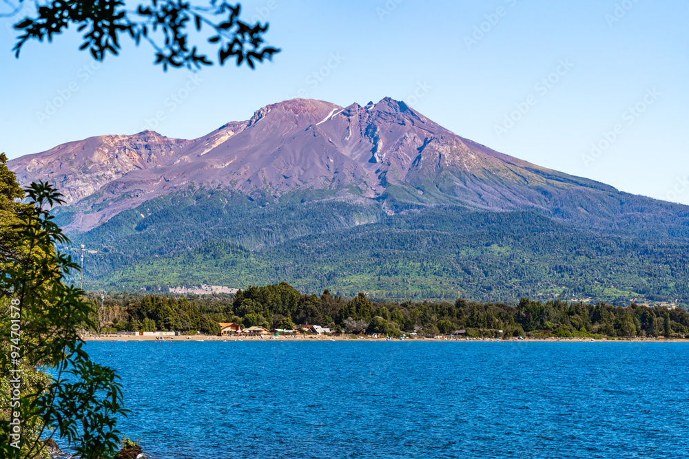 The Calbuco volcano and the Ensenada beach by the lake Llanquihue seen from the green lagoon paths The Calbuco volcano and the Ensenada beach by the lake Llanquihue seen from the green lagoon paths