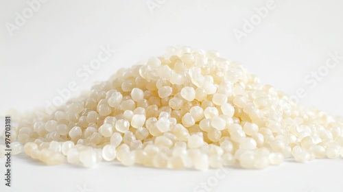 A pile of small, translucent beads resembling wax or resin.