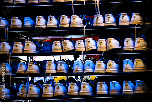 Bowling shoes rack with different sizes. Blue lighting.