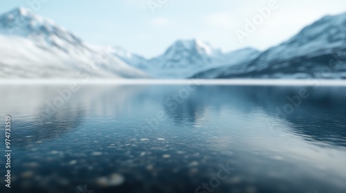 A serene mountain lake reflects the stunning icy peaks of the surrounding mountains, creating a breathtaking and tranquil nature scene with calm water and clear sky.