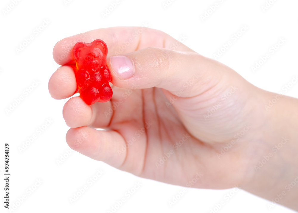 Gummy bear jelly in child hand on white background isolation