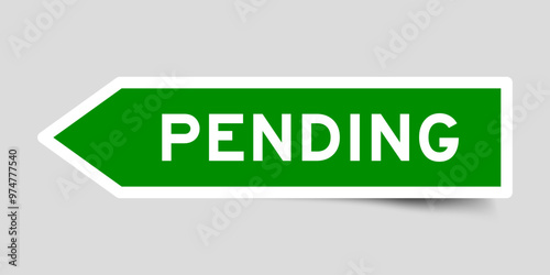 Green color arrow shape sticker label with word pending on gray background