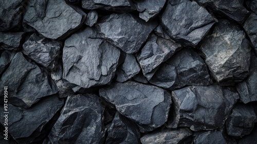 Describe a background with a rough, grainy texture in black or dark gray stone.