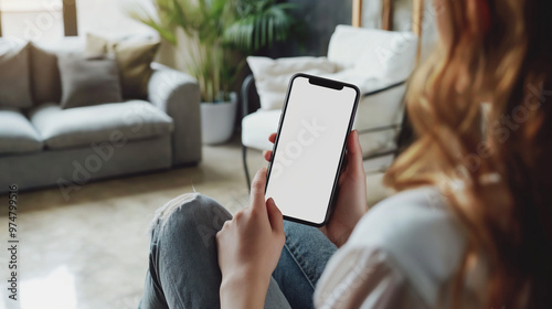 Woman Holding Smartphone with Blank Screen in Living Room