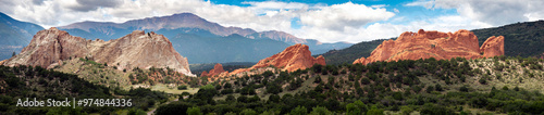 Beautiful panormaic view of Garden of the Gods in Colorado Springs. The Red Rock stone formations rise hundreds of feet above the desert floor. In the distance you can see Pikes Peak.