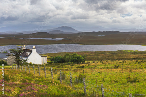 Scenic landscape view of the remote with houses dotted, Outer Hebrides, Scotland photo