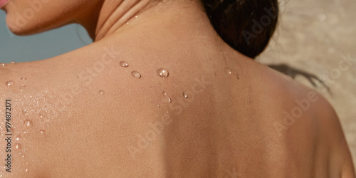 Wallpaper Mural Close-up of a woman’s shoulder with water droplets, showcasing smooth and hydrated skin. Torontodigital.ca