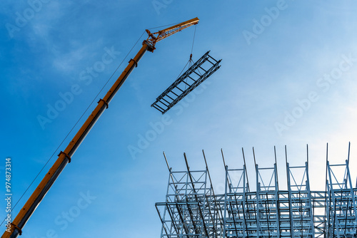 Cranes in process of ASRS Clad rack structural framework of warehouse building skeleton construction works