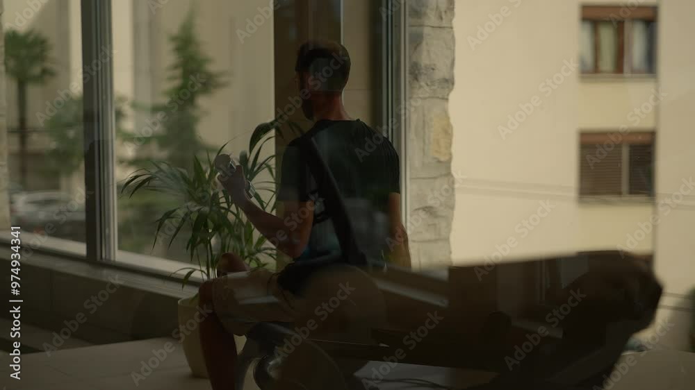 A contemplative figure is positioned by the window, gazing at an expansive urban view A contemplative figure is positioned by the window, gazing at an expansive urban view