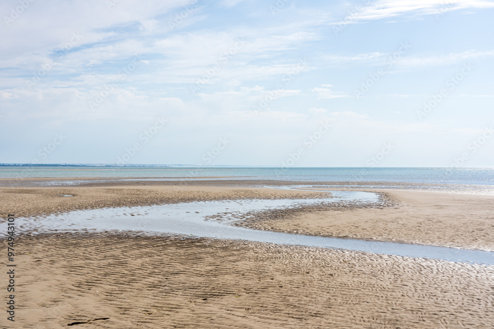Wide panoramic view of a beach on a sunny bright day in the Baie de Somme natural reserve in northern France by the English channel Wide panoramic view of a beach on a sunny bright day in the Baie de Somme natural reserve in northern France by the English channel