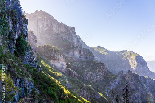 Panoramic view with sun streaks over Curral das Freiras on Madeira island on a bright early morning