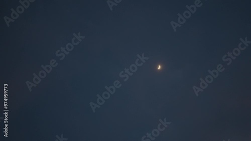 4K shot of moon against the night sky as seen from Keylong in Lahaul and Spiti district, Himachal Pradesh, India. Moon against the backdrop of the sky. Half crescent moon background with copy space. photo