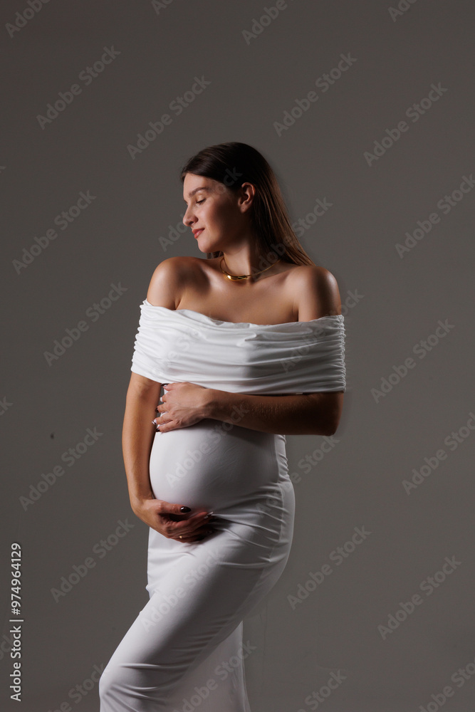 Beautiful young pregnant brunette girl. A woman waiting for a baby in a white dress with bare shoulders in the studio. Artistic smudges in the photo
Beautiful young pregnant brunette girl. A woman waiting for a baby in a white dress with bare shoulders in the studio. Artistic smudges in the photo