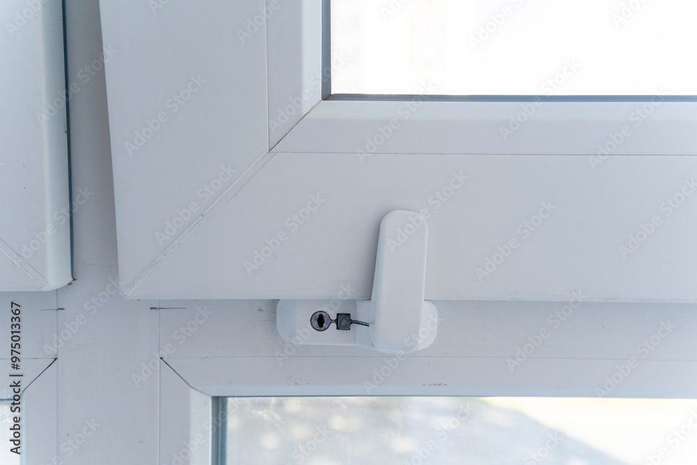 This image showcases a detailed closeup view of a pristine white window that features a secure lock on it, emphasizing its design and practicality in terms of safety and functionality This image showcases a detailed closeup view of a pristine white window that features a secure lock on it, emphasizing its design and practicality in terms of safety and functionality