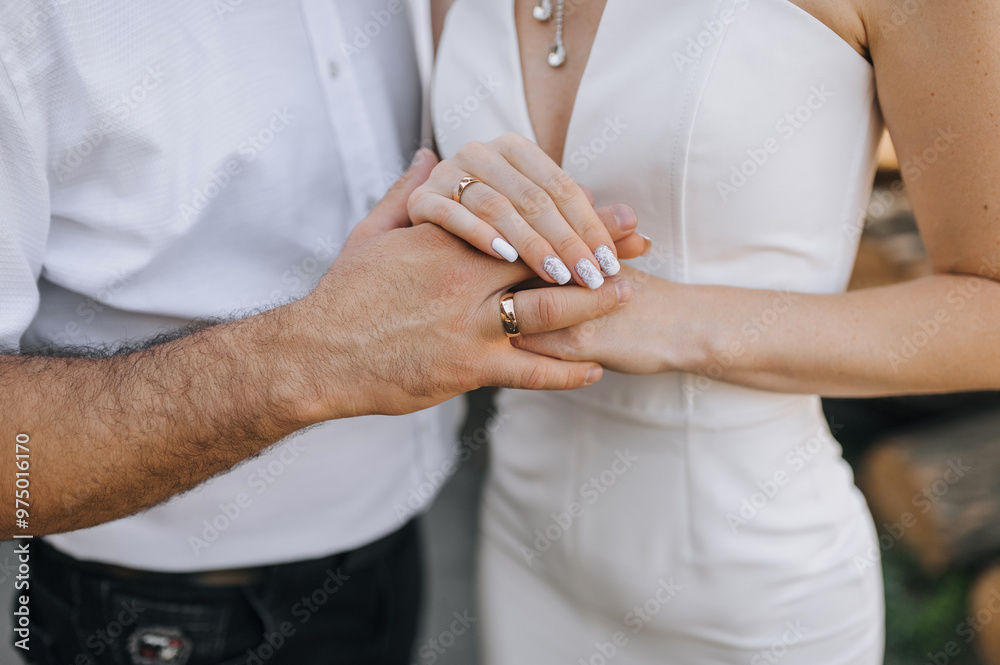 Happy newlyweds, bride and groom holding hands with gold rings on their fingers at the ceremony. Wedding photography, portrait. Happy newlyweds, bride and groom holding hands with gold rings on their fingers at the ceremony. Wedding photography, portrait.