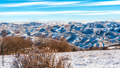 View from the mountain peak to the mountains and clouds below.