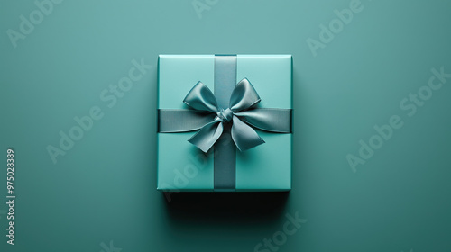 A mint gift box with a festive mint ribbon on a mint background.