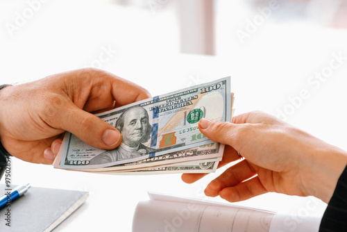 фотографія Businessman hand sending money to another business person