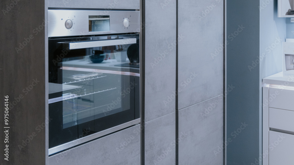 Modern kitchen with electric oven installed in a wall or kitchen element. Silver or stainless steel oven in a kitchen.. Modern kitchen with electric oven installed in a wall or kitchen element. Silver or stainless steel oven in a kitchen..