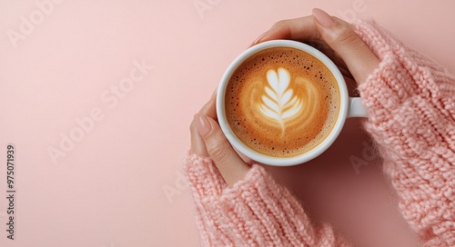 A cozy moment with a warm cup of latte art against a pastel pink background