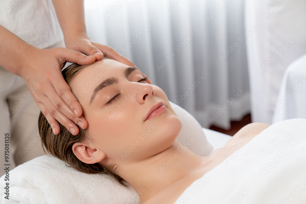 Caucasian woman enjoying relaxing anti-stress head massage and pampering facial beauty skin recreation leisure in dayspa modern light ambient at luxury resort or hotel spa salon. Quiescent Caucasian woman enjoying relaxing anti-stress head massage and pampering facial beauty skin recreation leisure in dayspa modern light ambient at luxury resort or hotel spa salon. Quiescent