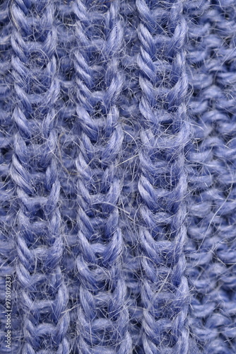 macro texture of purple crocheted sweater as a background, close-up of purple crocheted front surface, woolen texture of alpaca wool crocheted 