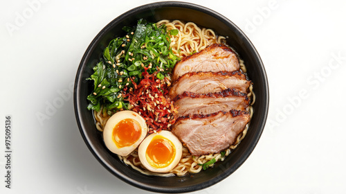 A bowl of ramen noodles with pork, egg, seaweed, and scallions.