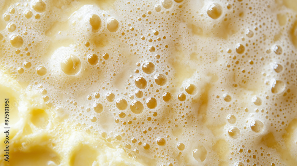 a close-up, top-down view of pancake batter bubbles, filling the entire frame with the focus on the tiny bubbles forming in the thick, creamy batter