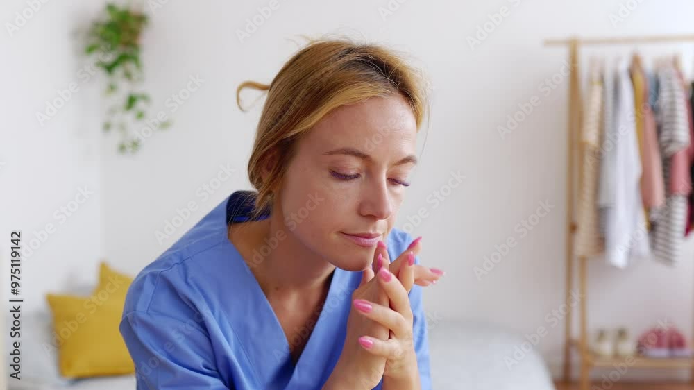 Stressed young female healthcare worker in blue scrubs resting in her bedroom after hard workday in the hospital. Hospital medical lifestyle and health care concept. Stressed young female healthcare worker in blue scrubs resting in her bedroom after hard workday in the hospital. Hospital medical lifestyle and health care concept.