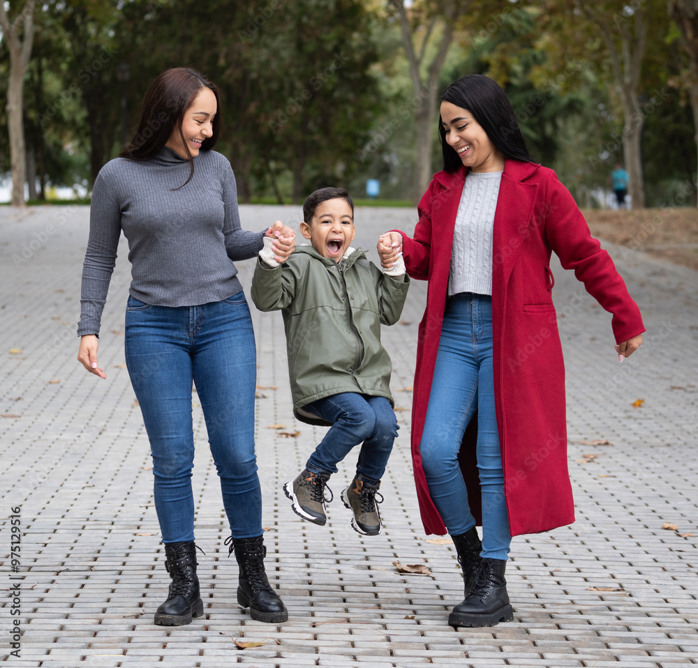 Lesbian family having fun with her son outdoors Lesbian family having fun with her son outdoors