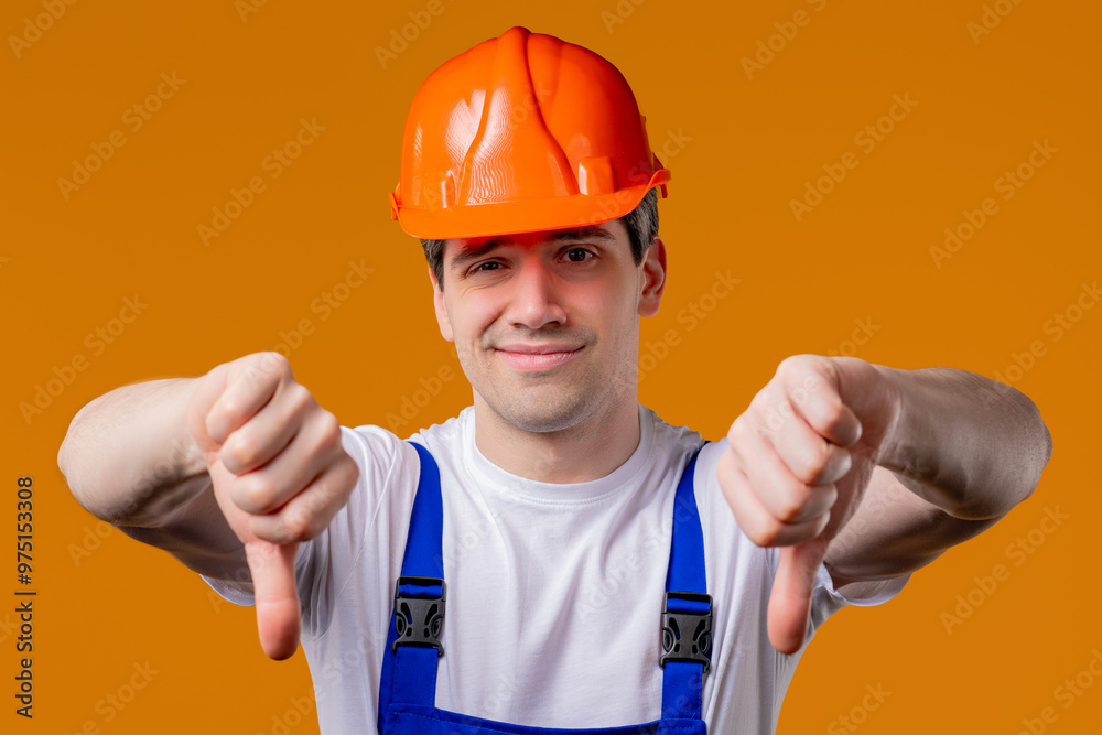 Mature 30s builder foreman with dislike.Handyman expresses thumbs-down on orange Mature 30s builder foreman with dislike.Handyman expresses thumbs-down on orange