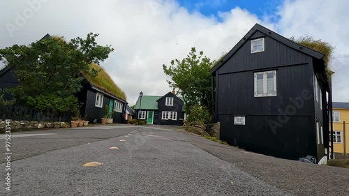 Beautiful architectural and nature views in the Old Town District in Tórshavn, the capital city of the Faroe Islands. Natural grass rooftops set against a cloudy blue sky. Streymoy, Faeroe Islands