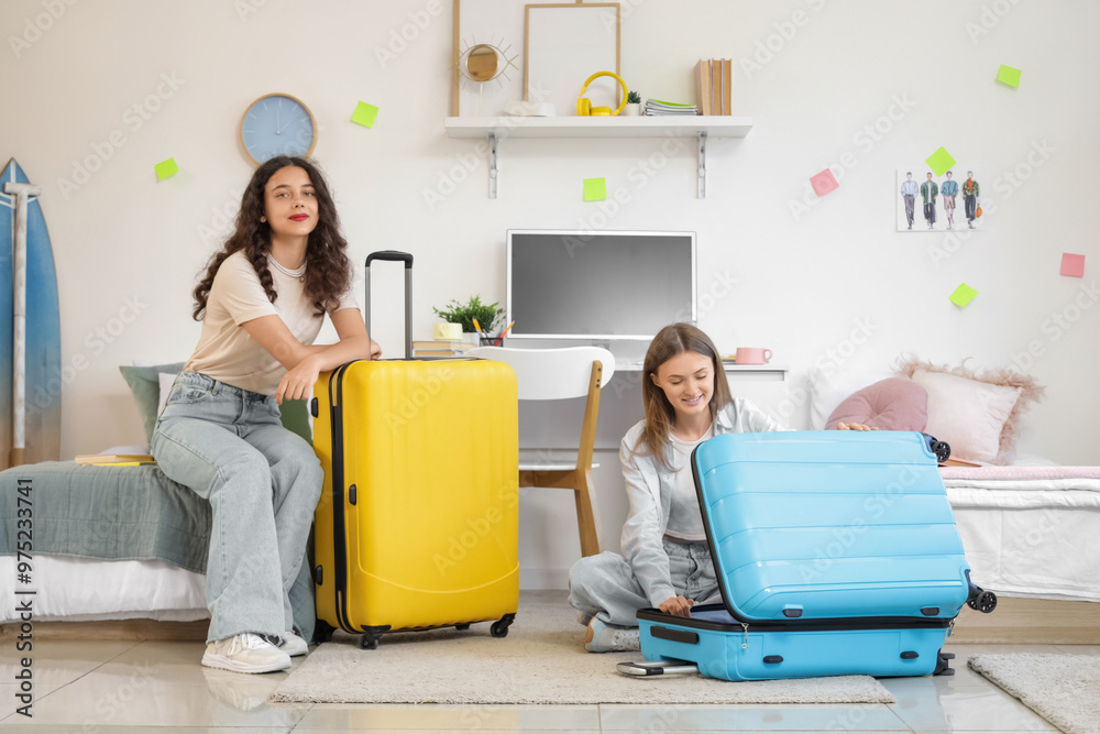 Female students with suitcases in dorm room on moving day Female students with suitcases in dorm room on moving day