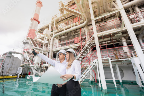 Asian male and female engineers bring invaluable knowledge to the nuclear power plant industry, driving progress and ensuring that energy systems are both effective and secure. photo