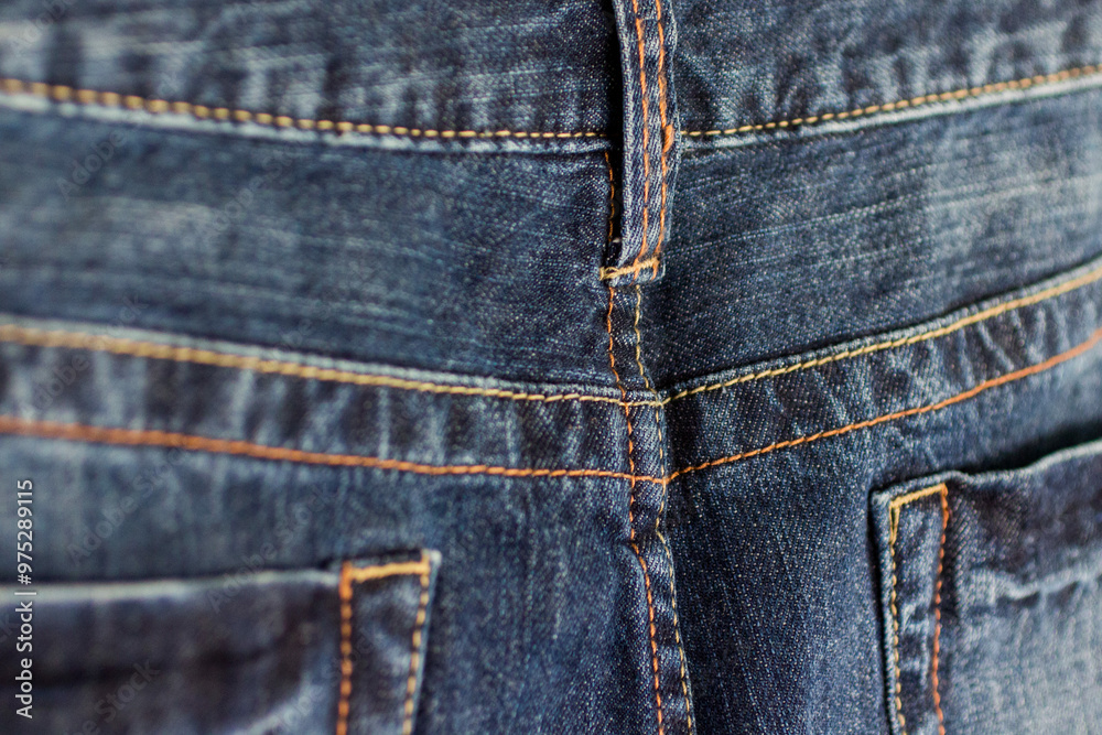 Close-up of waistband stitching on dark blue jeans Close-up of waistband stitching on dark blue jeans