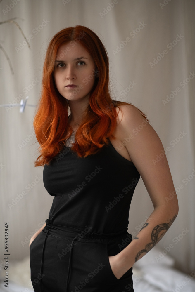 Portrait of a beautiful young red-haired girl in a studio. Portrait of a beautiful young red-haired girl in a studio.