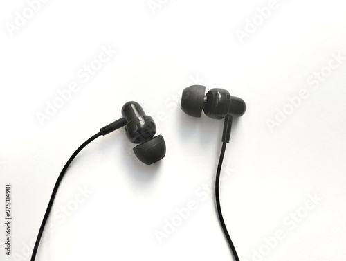 Black earphones with rubber tip covers for comfort in the ears. on a white background