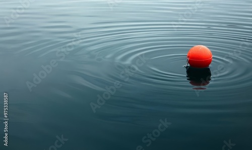 A lone, red fishing bobber floating on a calm, clear water surface