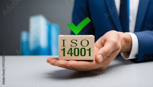 A businessman holding a small wooden block with a green checkmark and 'ISO 14001' written on it. ISO 14001 certified, iso 14001 environmental management system