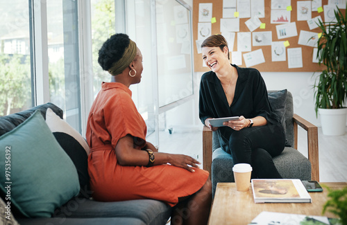 Businesswomen, meeting and collaboration with tablet on sofa for creative project ideas and brainstorming. Professional, happy employees and laughing for funny design strategy, workflow and feedback