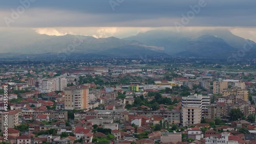 Shkoder city in Albania. Drone crane shot. Cityscape with mountain landscape background. photo