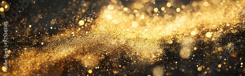 A close-up of a dark background sprinkled with gold glitter, creating a sparkling and festive atmosphere. The glitter is out of focus, creating a bokeh effect.