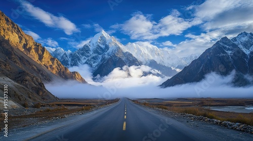 Obraz na płótnie A stunning view of cloud-covered Passu Cones with the Karakoram Highway stretching through the calm, picturesque landscape of Gojal, Hunza Valley. w salonie