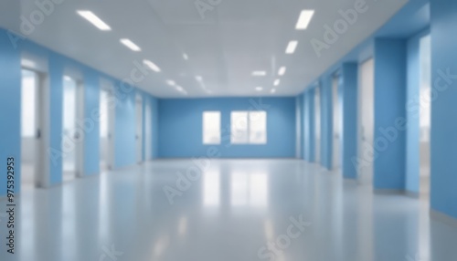 A long, empty corridor with blue walls and a white ceiling, featuring multiple doors and windows.