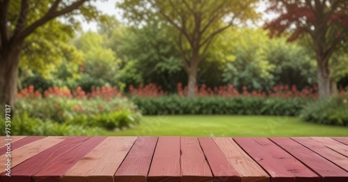 A wooden table with a red top sits in the foreground, with a lush garden and trees in the background.