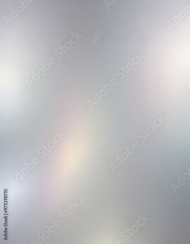 The image is a blurred, abstract representation of a cloudy sky, with a gradient of gray and white colors.