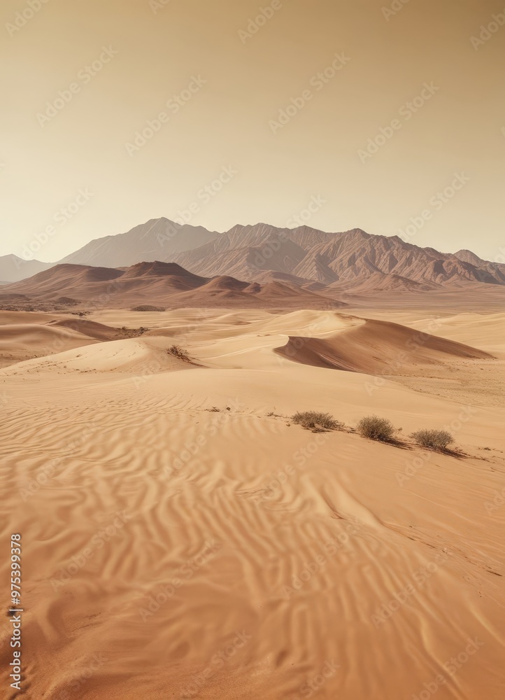 A vast expanse of sand dunes stretches out under a hazy sky, with a distant mountain range providing a striking backdrop. A vast expanse of sand dunes stretches out under a hazy sky, with a distant mountain range providing a striking backdrop.
