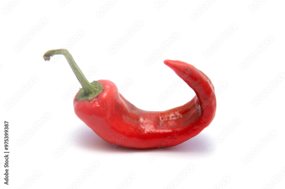 A red pepper is cut in half and has a long stem