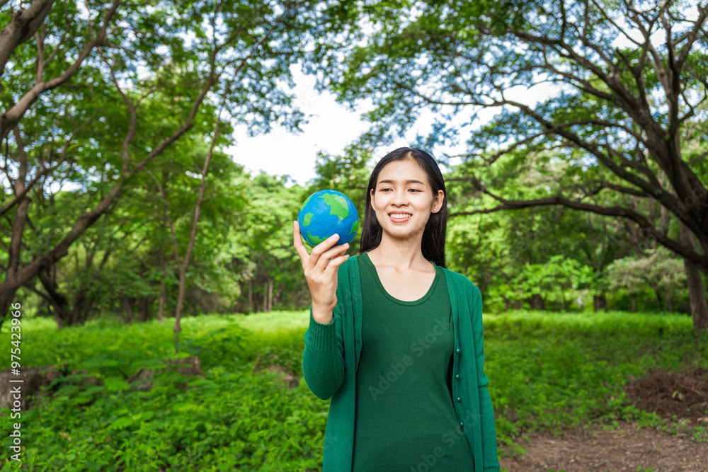 Forest conservationist holds small globe in hands, symbolizing global responsibility for protecting planet. Standing outdoors in green park, sustainability, commitment to achieving net-zero impact. Forest conservationist holds small globe in hands, symbolizing global responsibility for protecting planet. Standing outdoors in green park, sustainability, commitment to achieving net-zero impact.