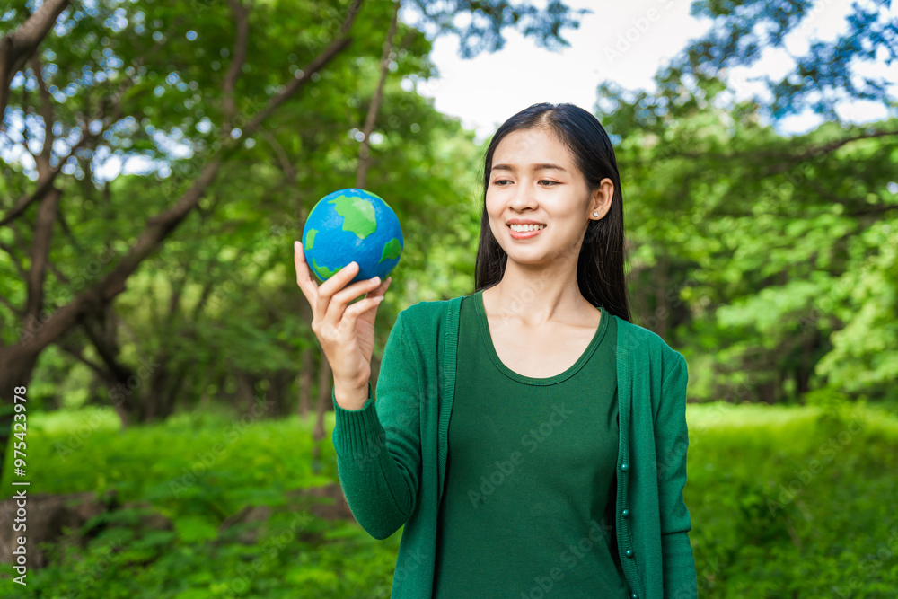 Forest conservationist holds small globe in hands, symbolizing global responsibility for protecting planet. Standing outdoors in green park, sustainability, commitment to achieving net-zero impact. Forest conservationist holds small globe in hands, symbolizing global responsibility for protecting planet. Standing outdoors in green park, sustainability, commitment to achieving net-zero impact.